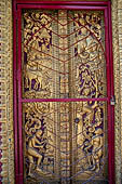 Luang Prabang, Laos - Wat Khili, the window shutters of the sim are decorated with gilded woodcarvings representing  probably the Prince Siddhartha. 